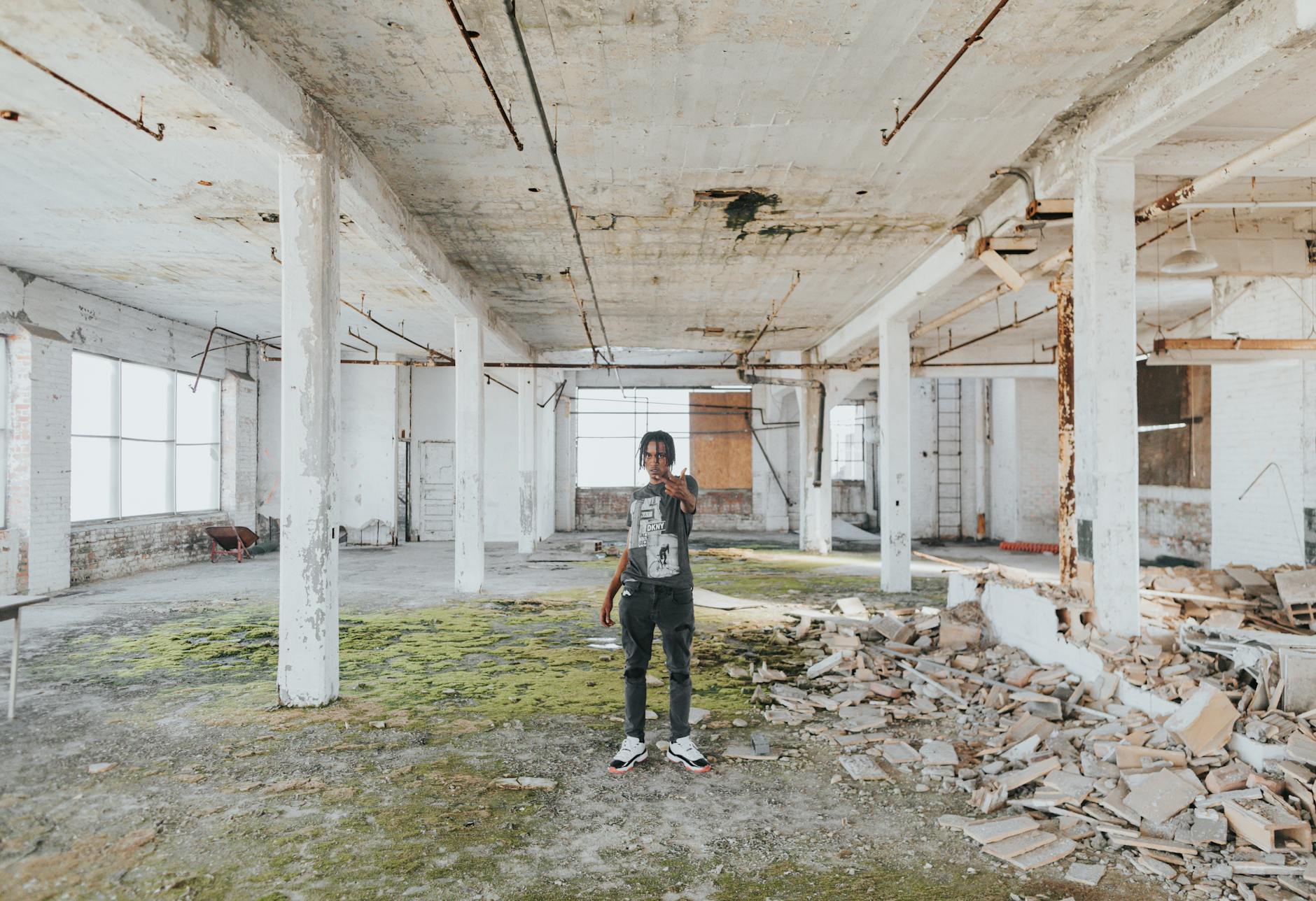 Young person exploring an urban warehouse space in Detroit