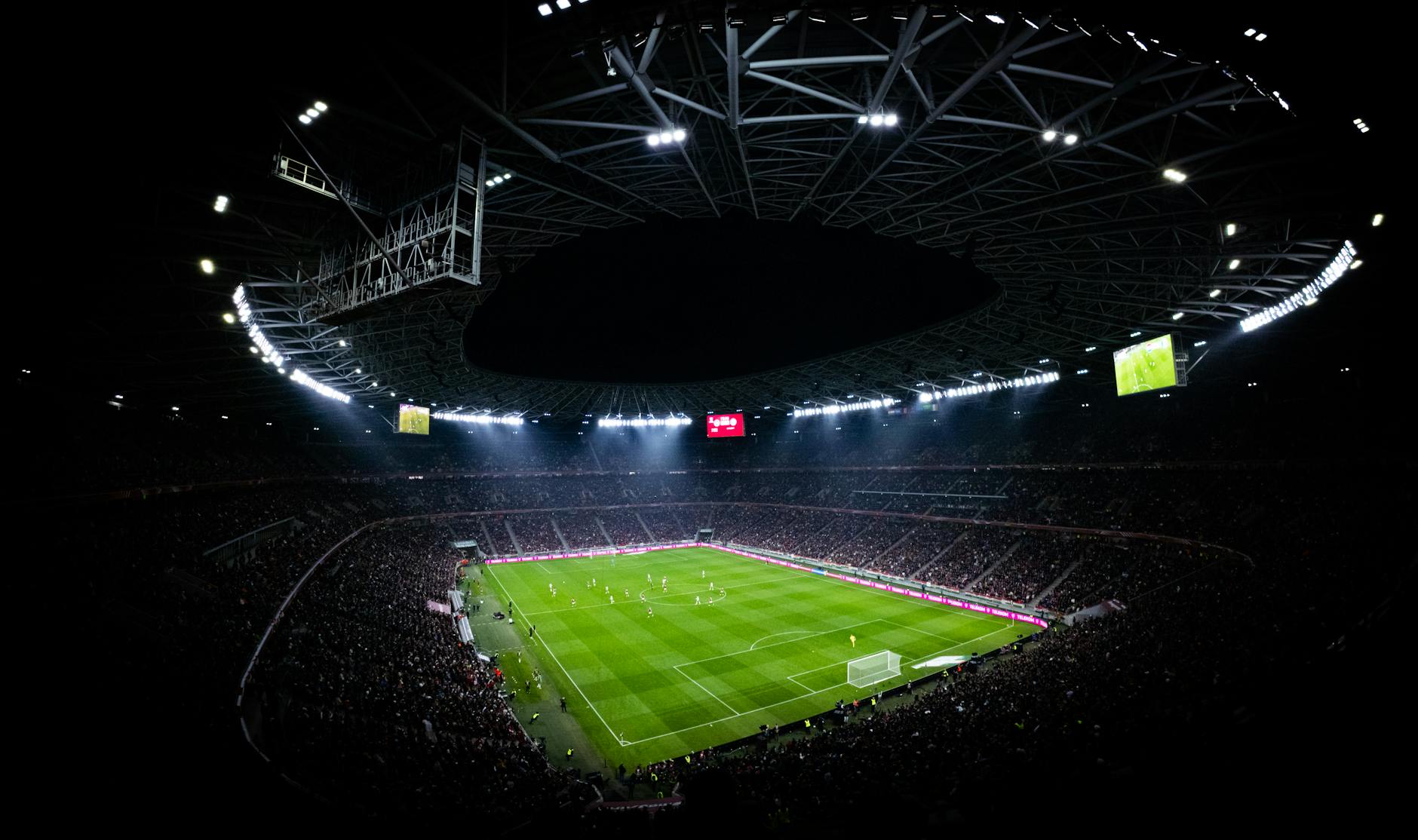 Aerial view of a packed stadium under lights during a night game