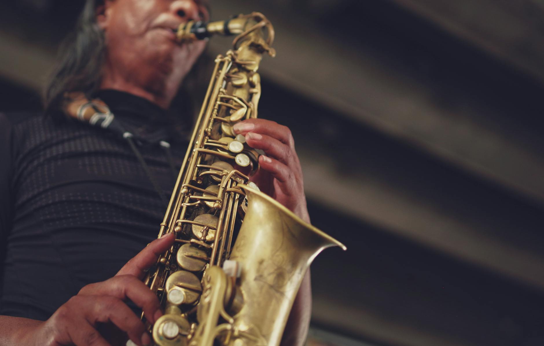Jazz musician performing with a saxophone on stage