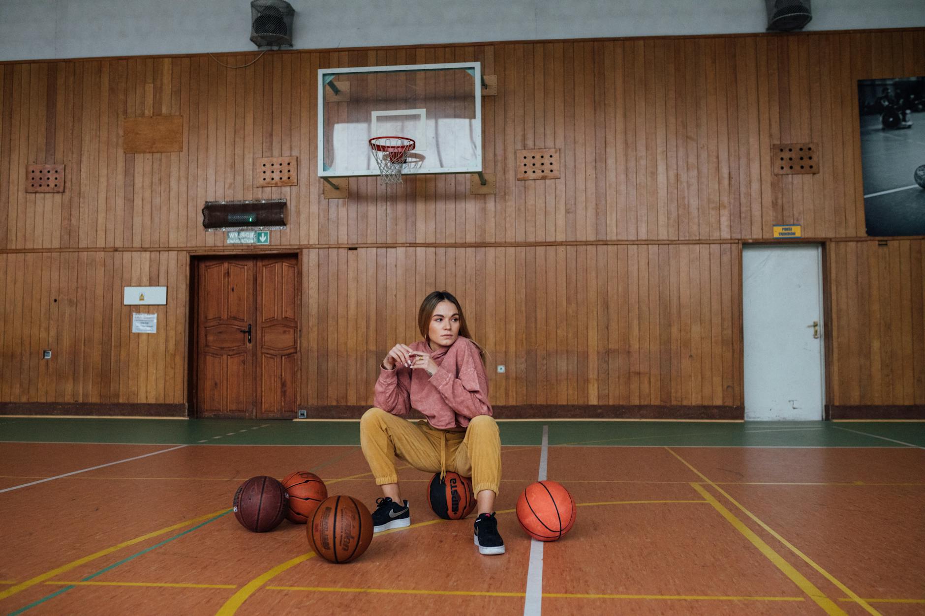 Female athlete posing confidently on a basketball court