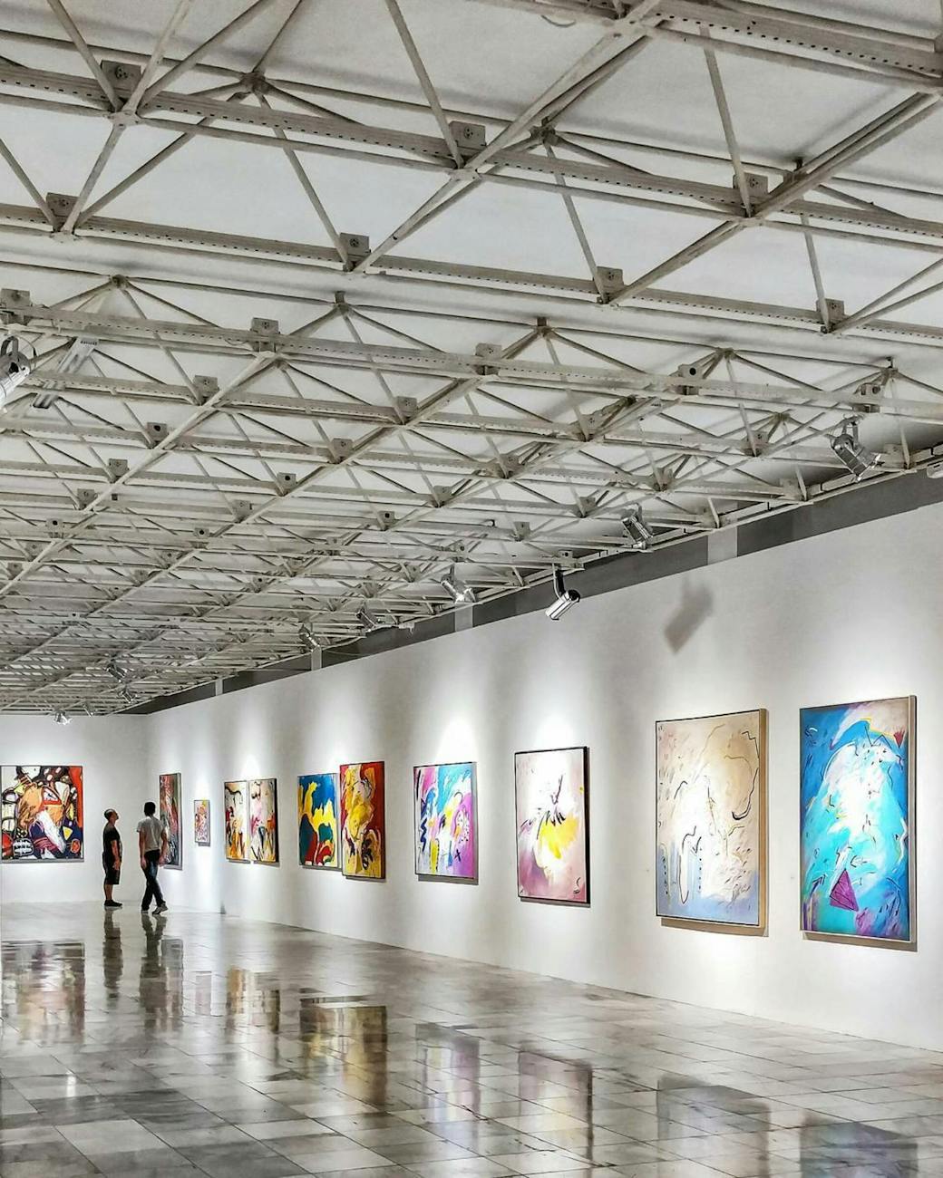 Museum gallery with art on walls and wooden floor