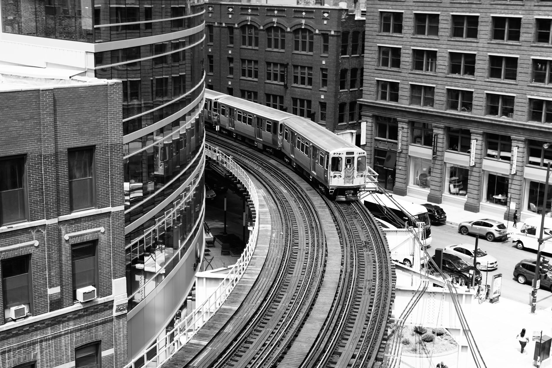 Train on curved tracks passing through an urban area